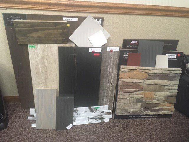 A bunch of tiles and stone samples on the floor