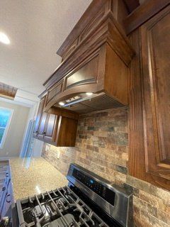 A kitchen with stainless steel appliances and wooden cabinets.