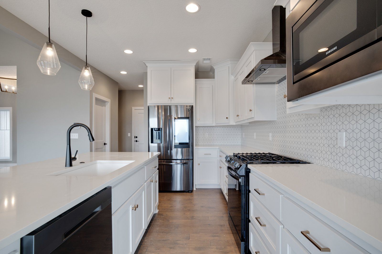 A kitchen with white cabinets and stainless steel appliances.