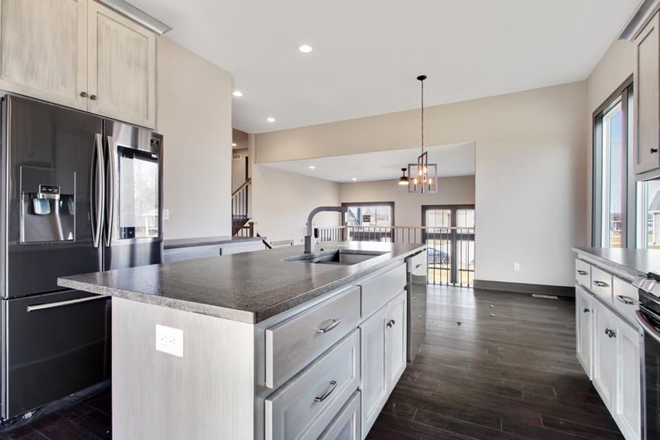 A kitchen with a large island and stainless steel appliances.