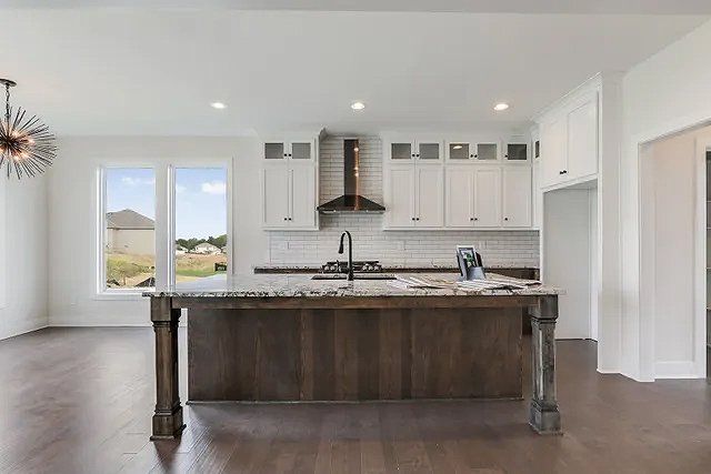 There is a large island in the middle of the kitchen.