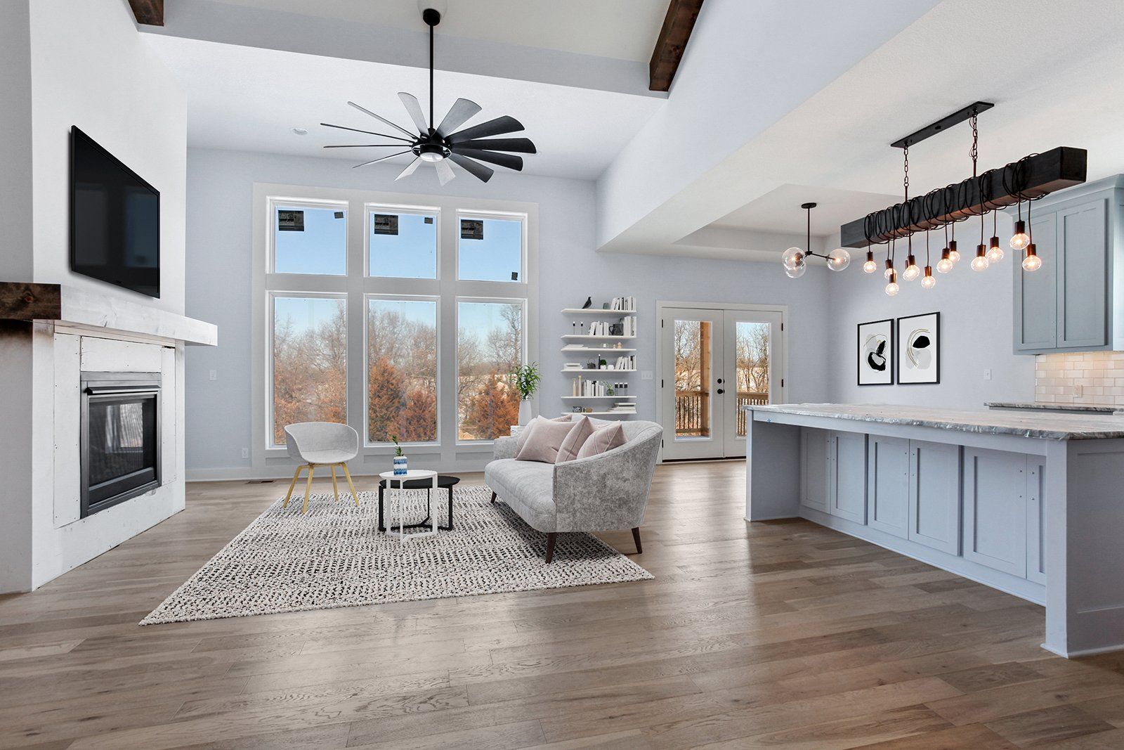 A living room with a couch , fireplace , television and ceiling fan.