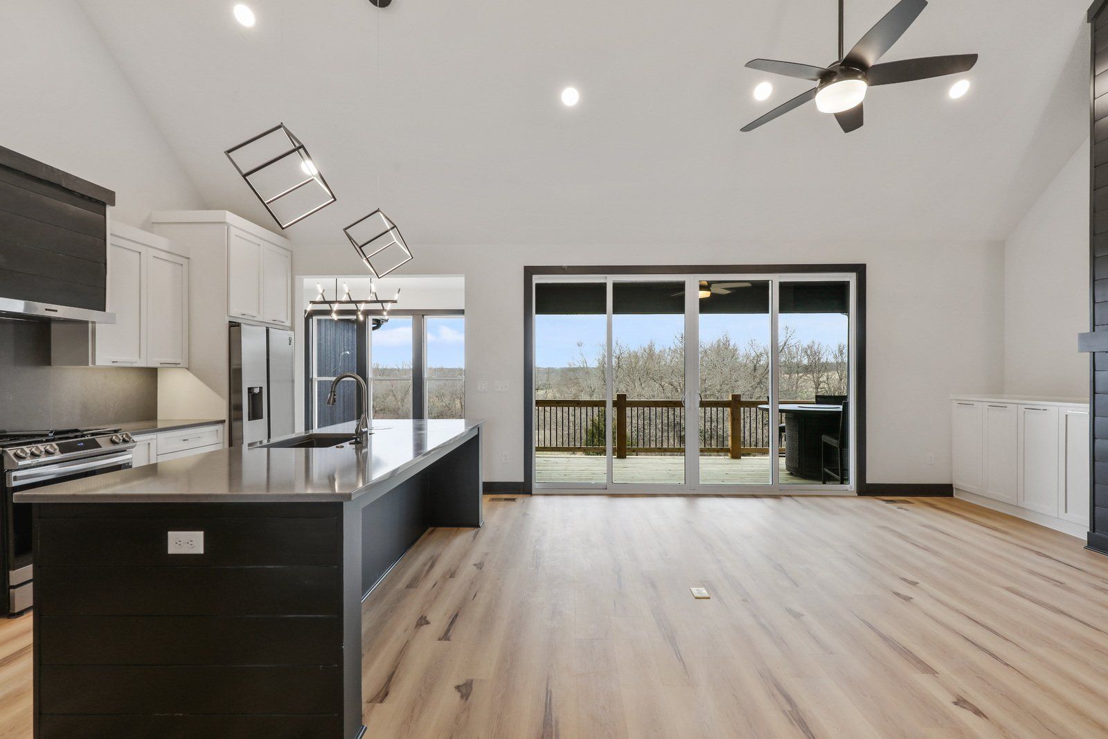 A kitchen with sliding glass doors and a ceiling fan.