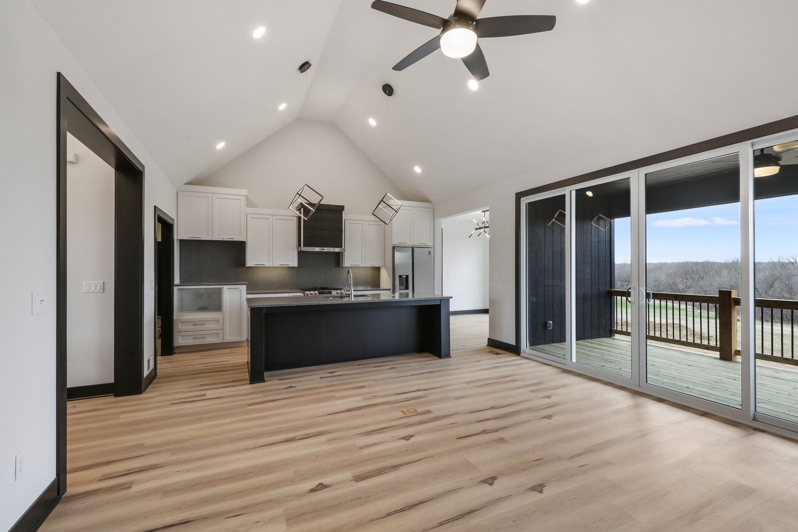 A kitchen with a ceiling fan and sliding glass doors