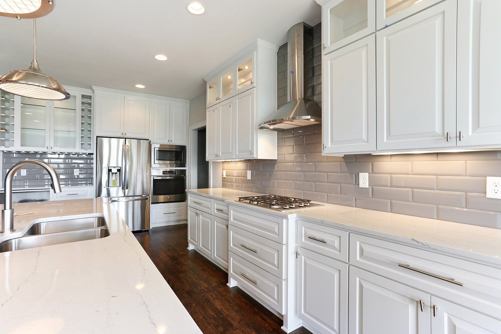 A kitchen with white cabinets and stainless steel appliances.