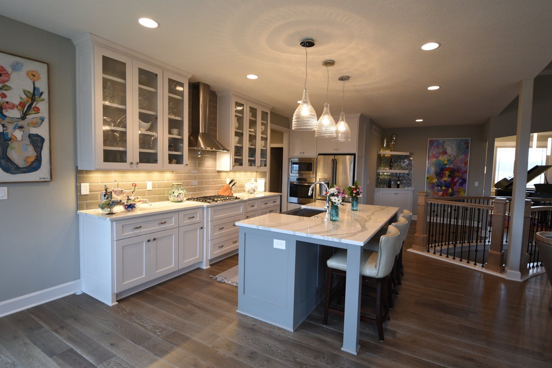 A large kitchen with a large island in the middle of it.