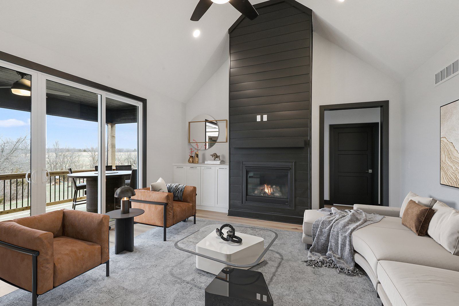 A living room with a couch , chairs , coffee table and fireplace.