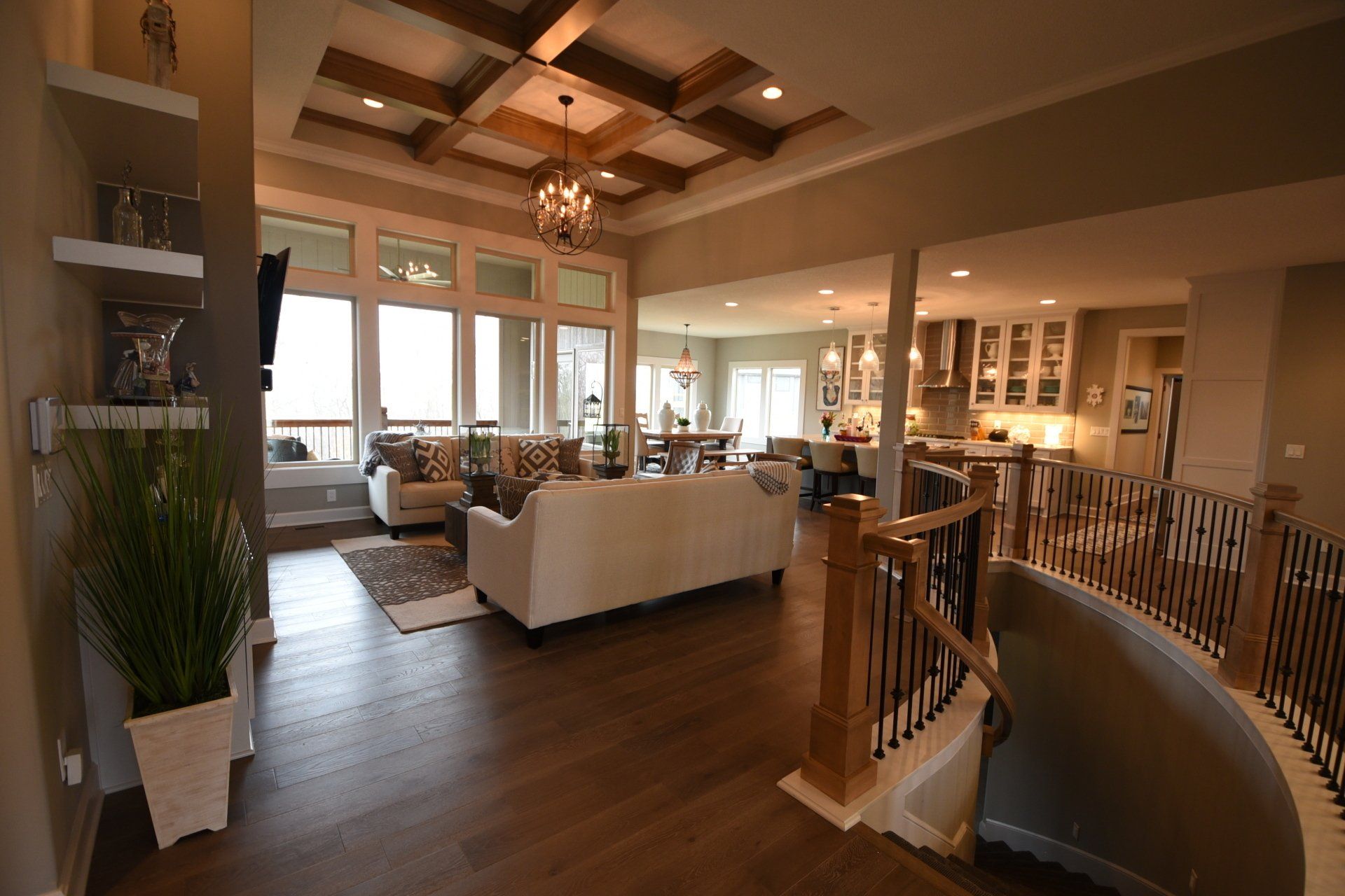 A living room with a couch and stairs in a house.