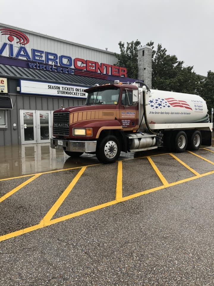 Brown and white tanker truck parked in front of a Viabro Center building.