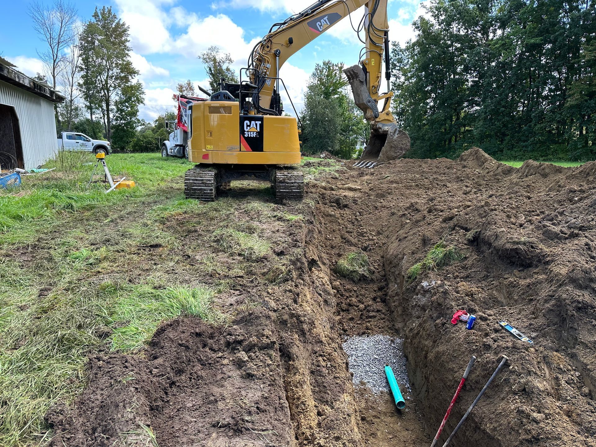 A bulldozer is digging a hole in the dirt in a field