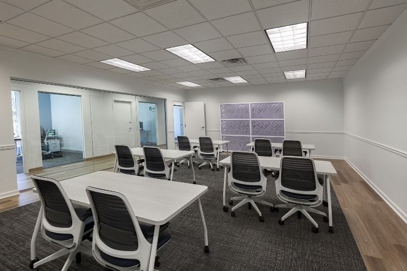 A large room with tables and chairs in it.