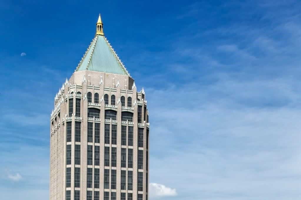 A tall building with a blue sky in the background.
