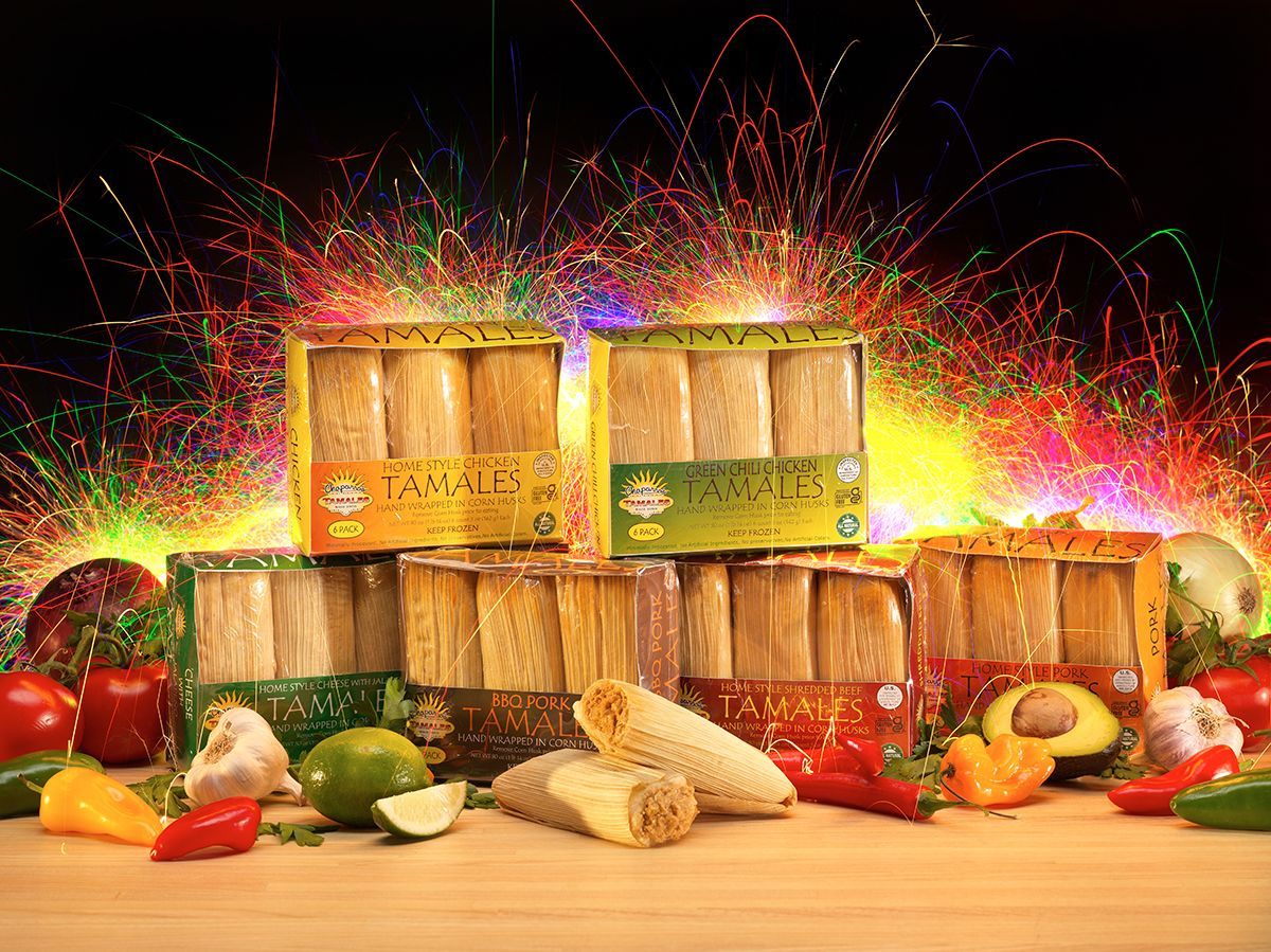 Wooden fruit crates stacked amid colorful fireworks-like sparks, with assorted fresh produce in front.
