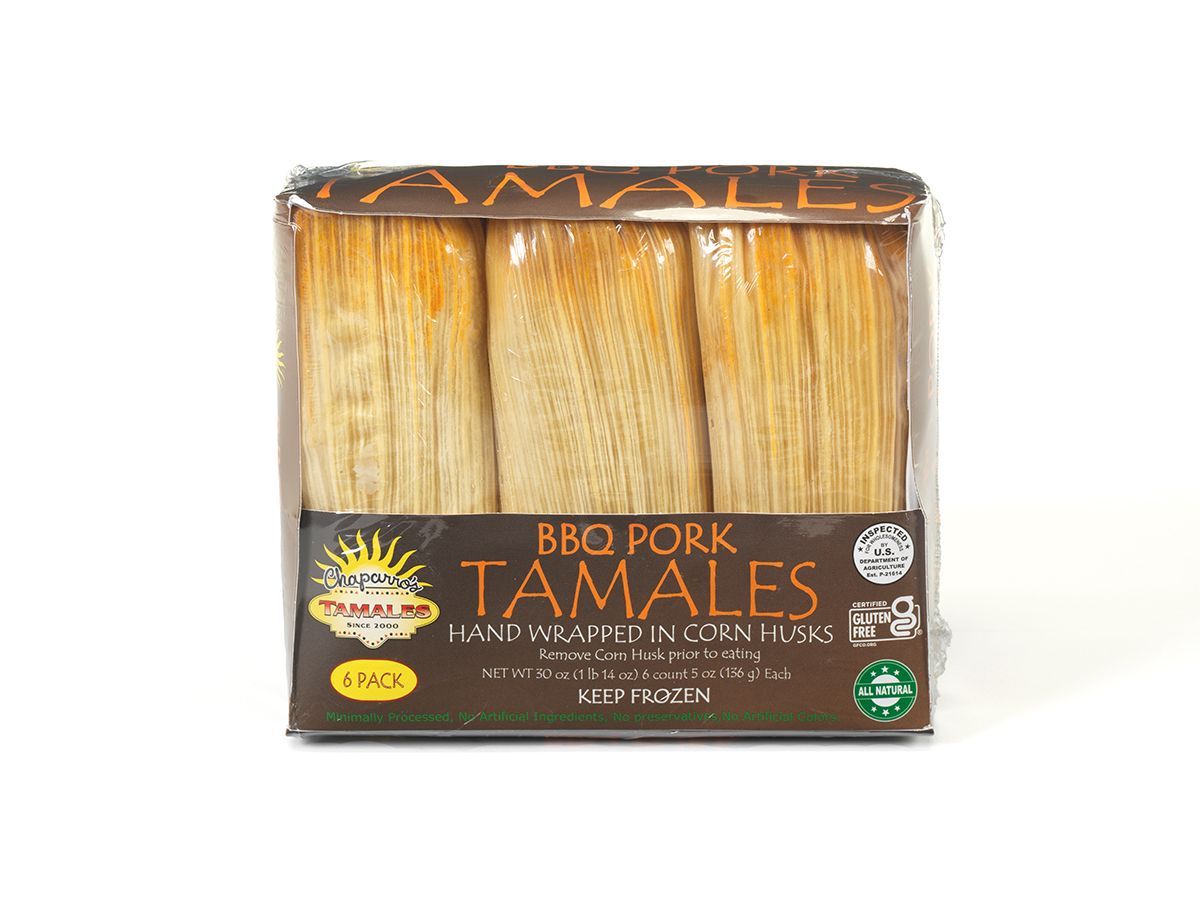 Packaged BBQ pork tamales in corn husks, neatly stacked in a clear plastic container.