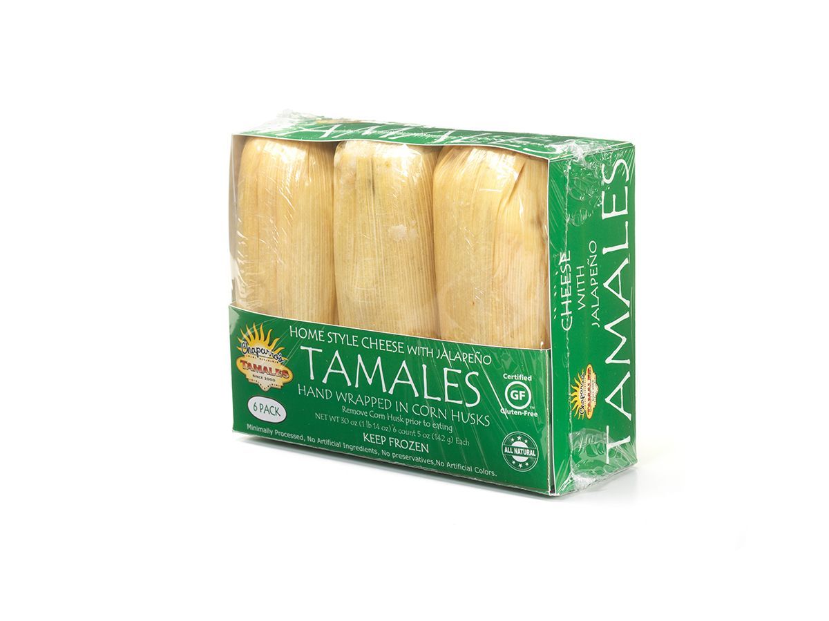 Green package of tamales with three corn husk tamales visible through the clear front window