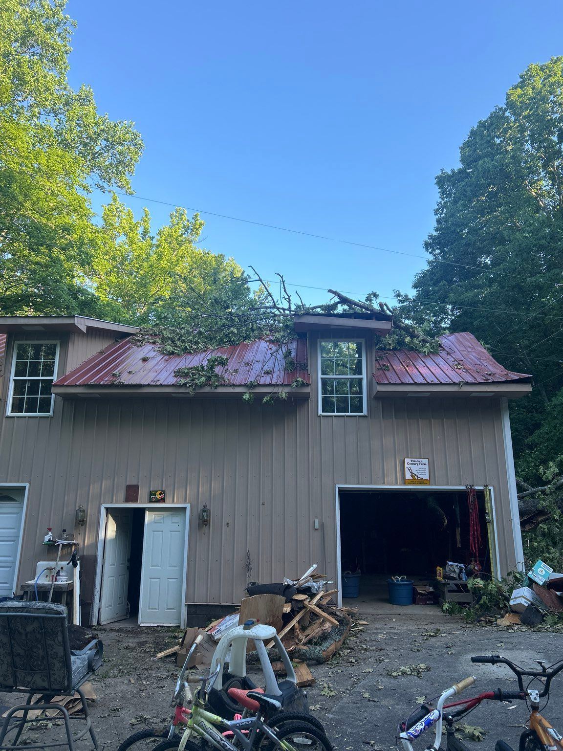 A house with a red roof and a garage with bikes parked in front of it.