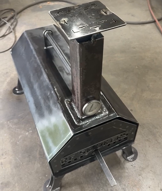 Welded metal machine with top platform, post, and front vent openings.