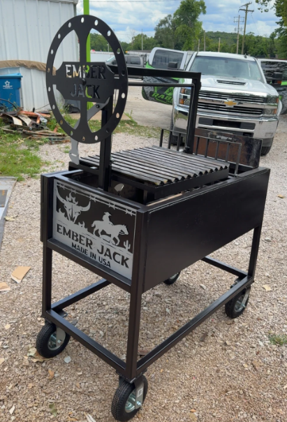 Black Ember Jack grill with turning wheel, on wheels, outside.