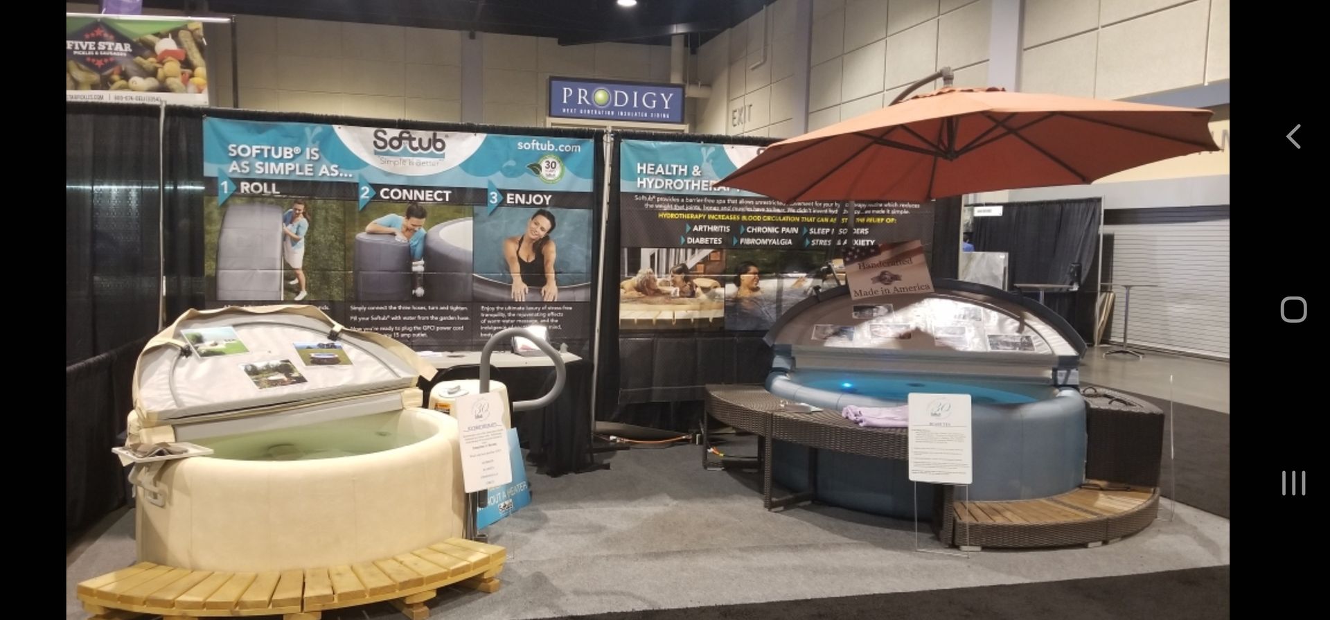 Hot tub display with umbrella at trade show.