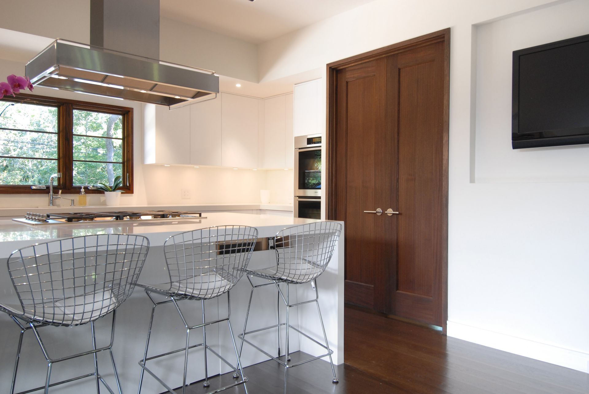 A kitchen with a large island and stools
