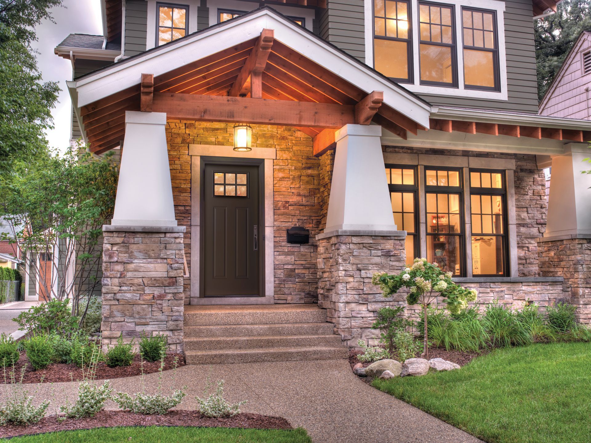 A house with a stone facade and a black door