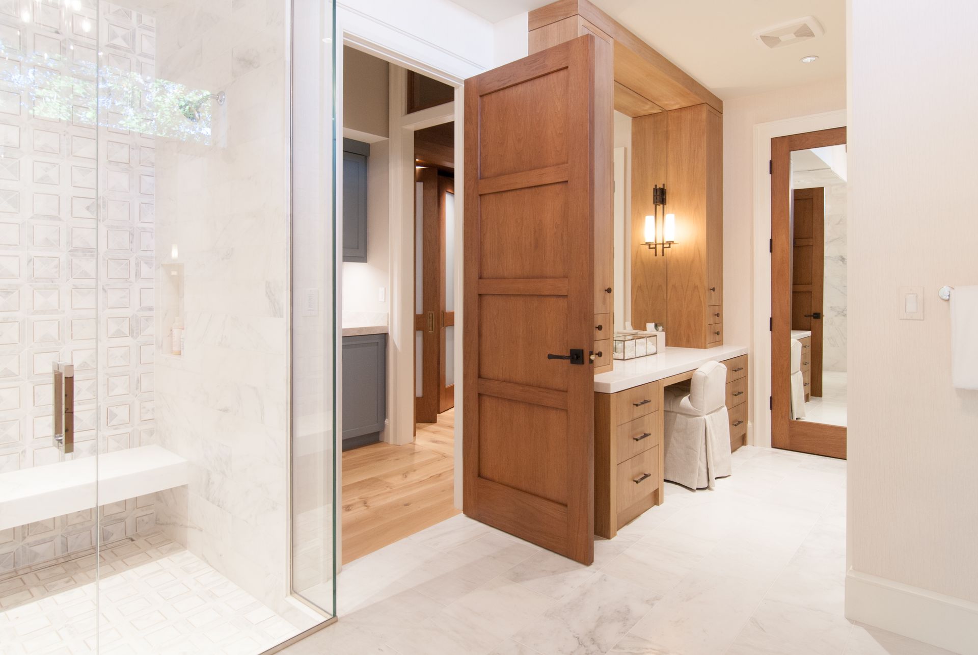A bathroom with a walk in shower and a vanity.