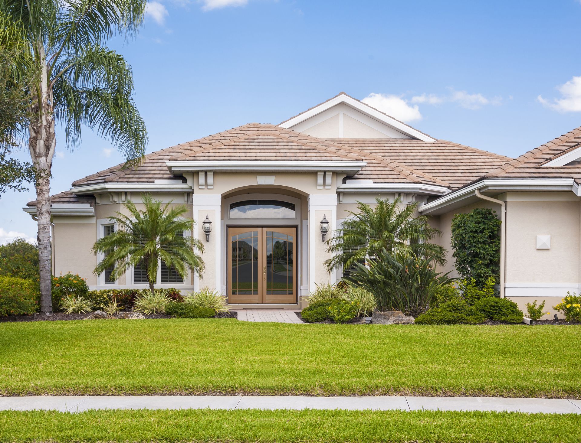 A large house with a lush green lawn in front of it.