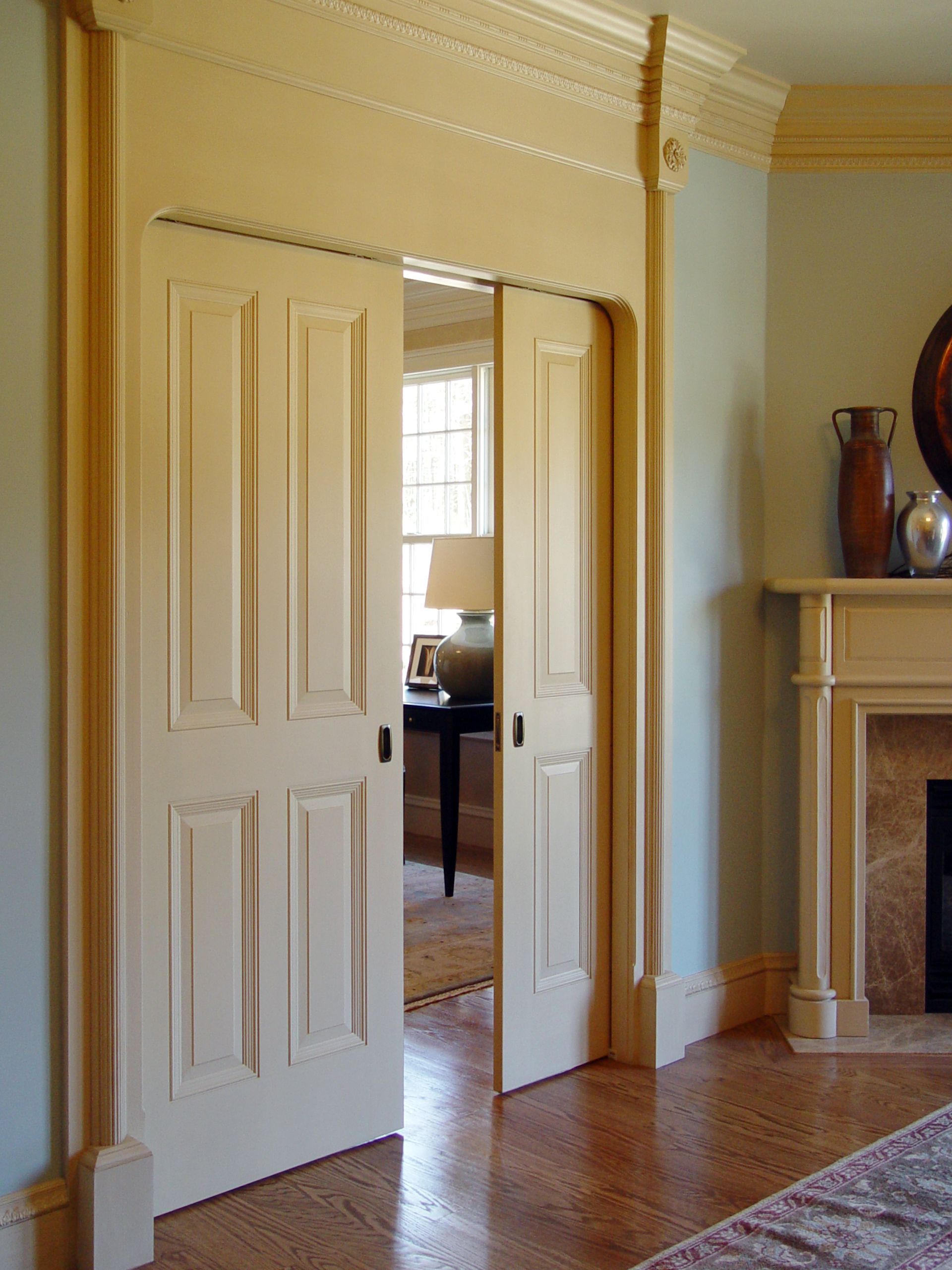 A living room with a fireplace and sliding doors