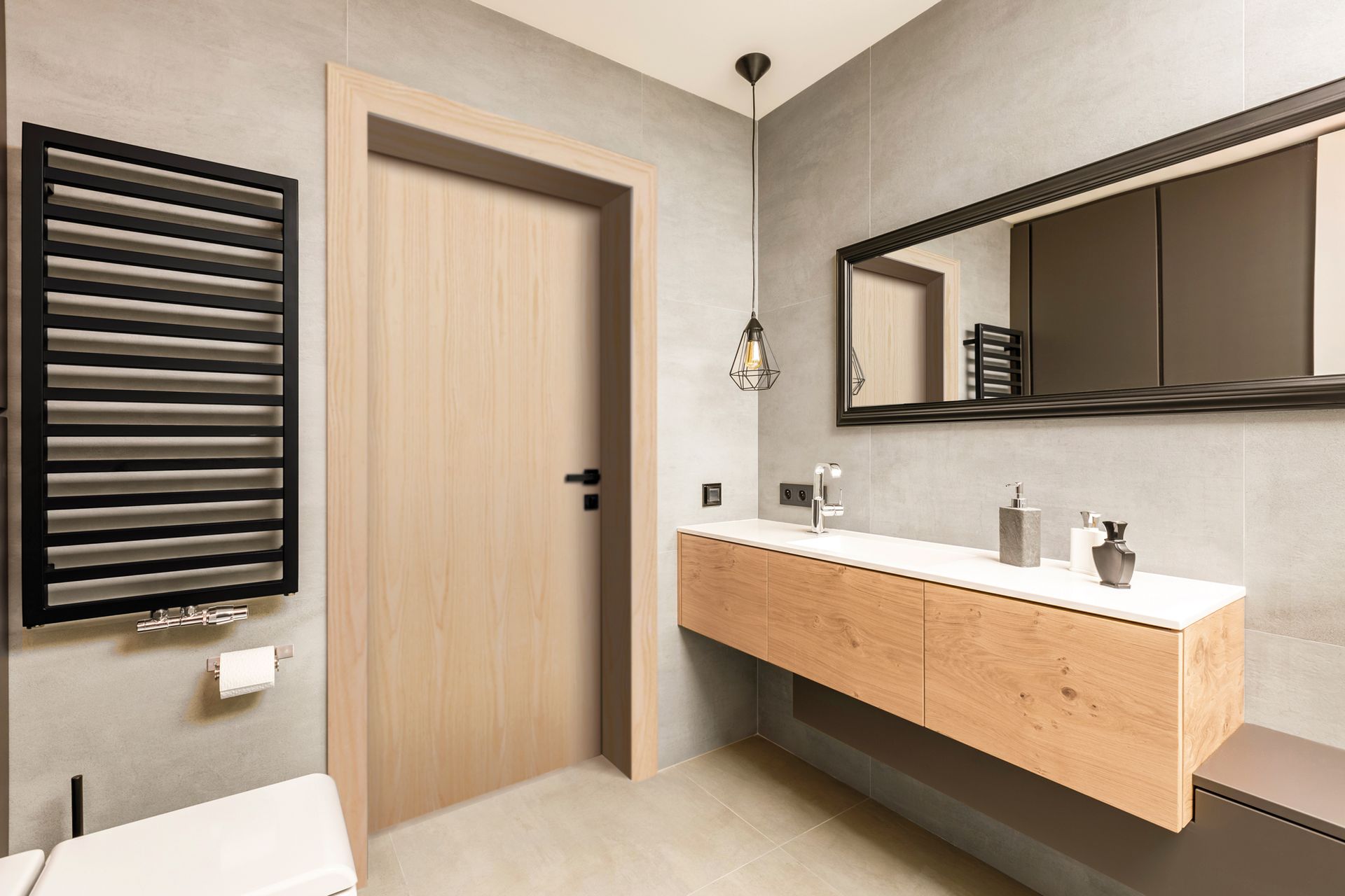 A bathroom with a toilet, sink, mirror and towel rack.