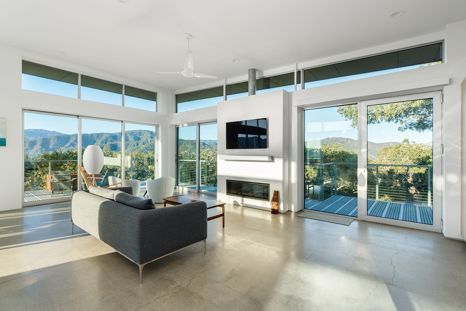 A living room with a couch, fireplace, and television.