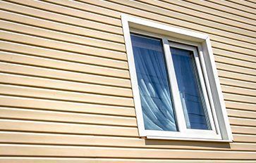 A close up of a window on the side of a house.