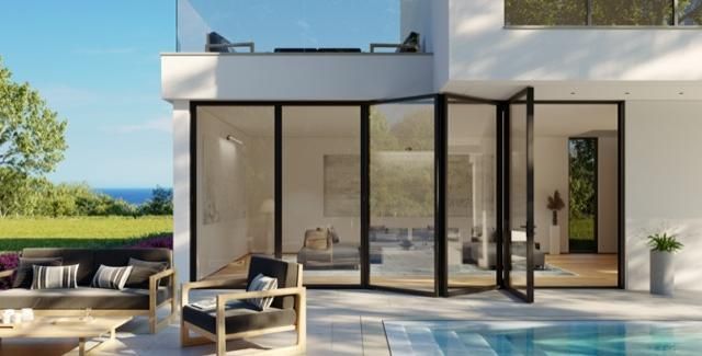 A white house with a swimming pool in front of it.