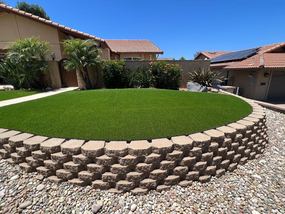 A house with a large circular lawn in front of it.