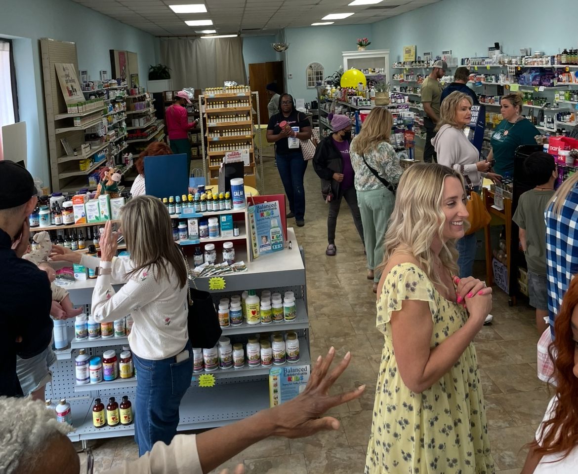 A group of people are standing in a pharmacy