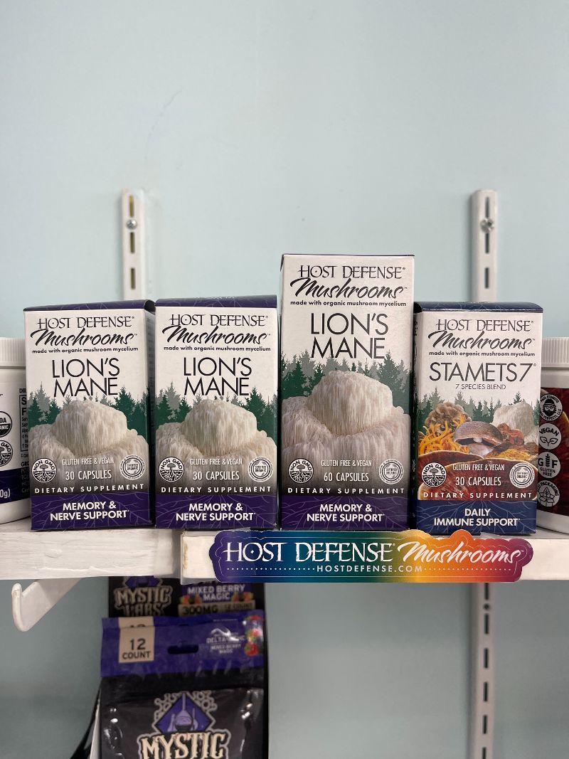 A shelf filled with boxes of lion 's mane mushrooms.