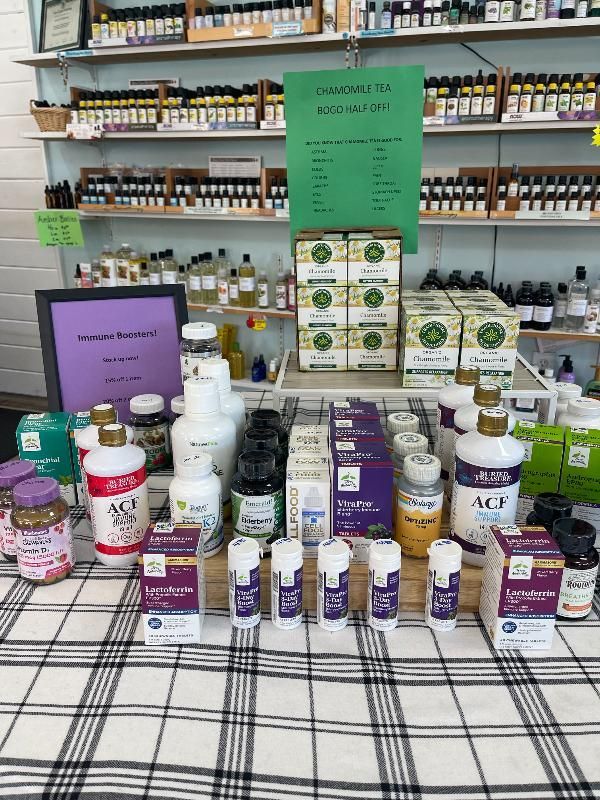 A table with a lot of bottles and boxes on it in a store.