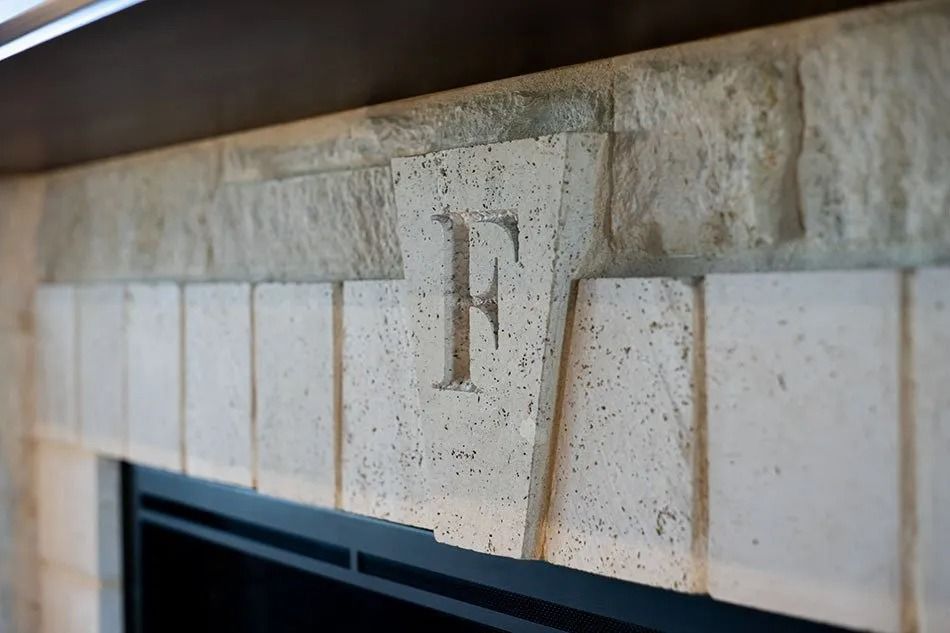 Limestone fireplace mantle with carved