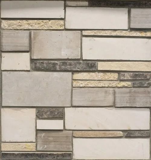 Wall tile with a random pattern of rectangular stones in shades of cream, beige, and gray.