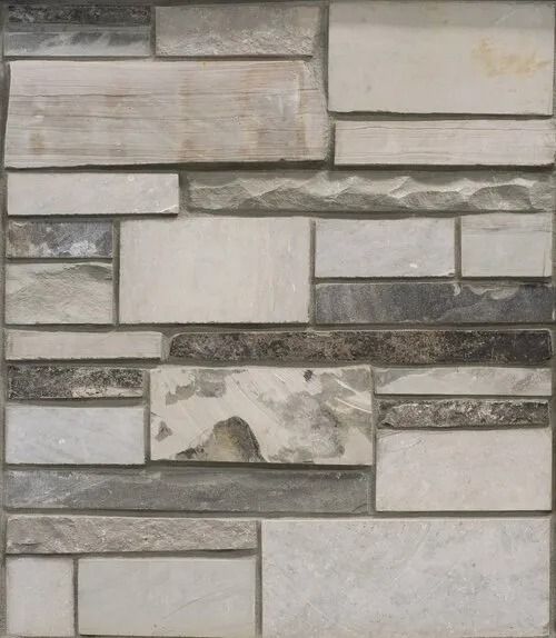 Stone tile wall with varying sizes and shades of gray, beige, and brown.
