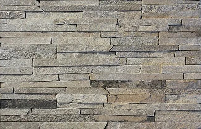 Stone wall with horizontal, rectangular, gray-toned pieces of varying sizes and textures.