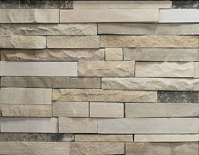 Stone veneer wall with varied rectangular blocks in neutral tones.