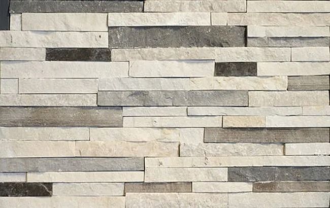 Stone wall cladding with horizontal rectangular pieces in white and gray.