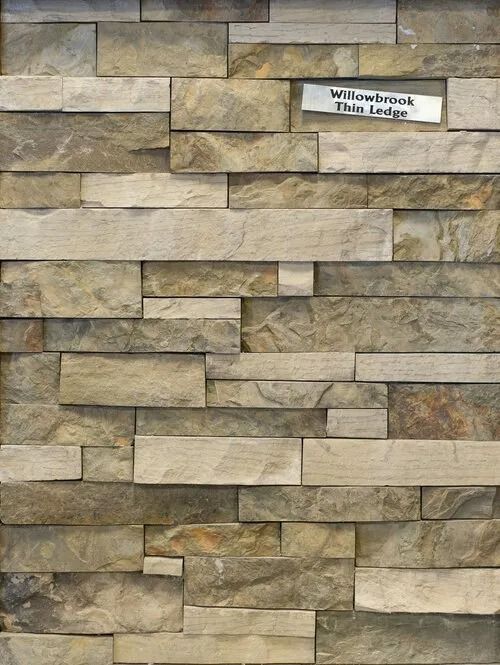 Textured stone wall in varying shades of tan and brown. Labeled