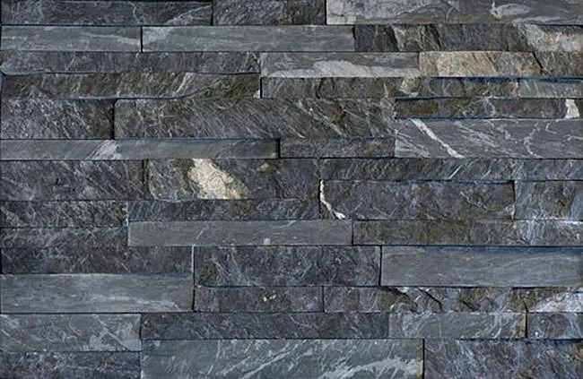 Dark gray stacked stone wall.