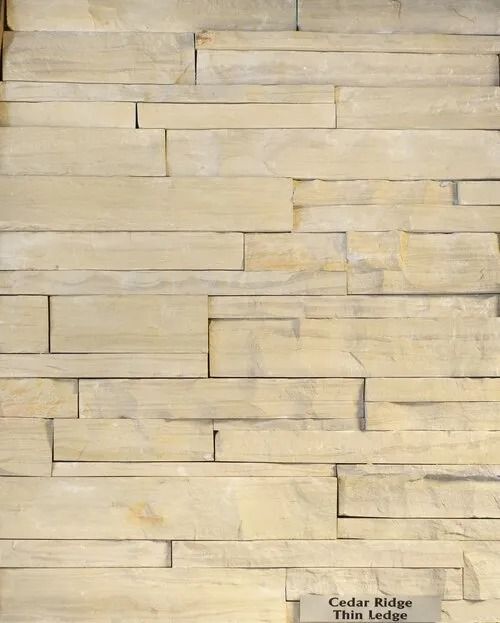 Stacked rectangular, light-colored stone wall. The style is called Cedar Ridge Thin Ledge.