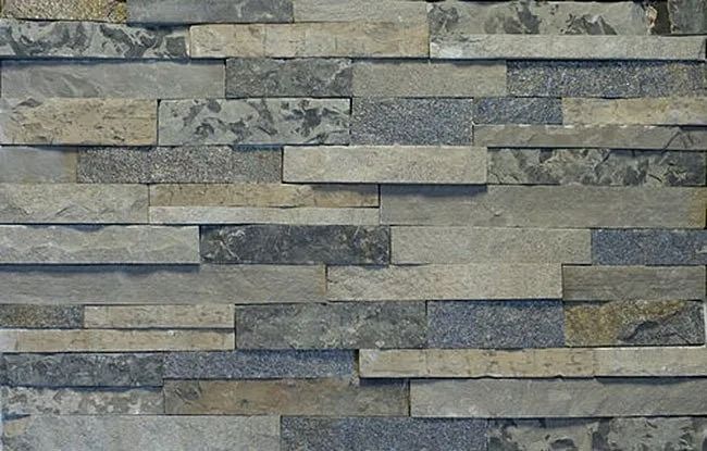 Gray and beige stacked stone wall with varying textures.