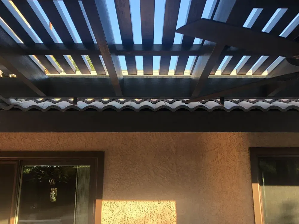A ceiling fan is hanging from the roof of a house