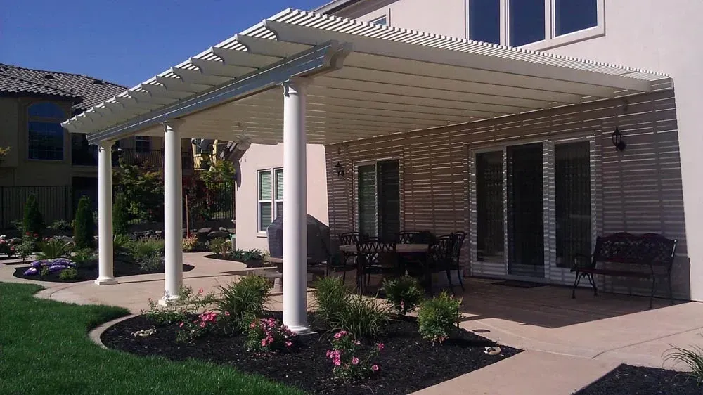 A house with a patio and a pergola in the backyard