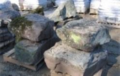 Large gray rocks stacked on a pallet, possibly for landscaping or construction.