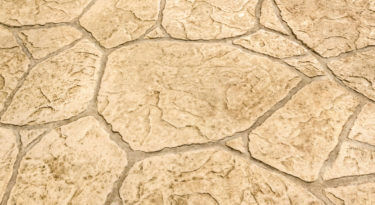 A close up of a stone wall with a pattern of large rocks